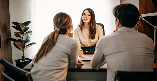 man and woman consulting with lawyer