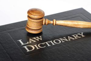 Law dictionary and gavel on white background